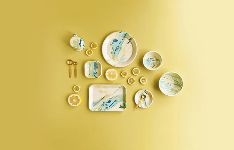 BORNN Lemon Cream enamelware, lemons and cutlery in a bright table setting
