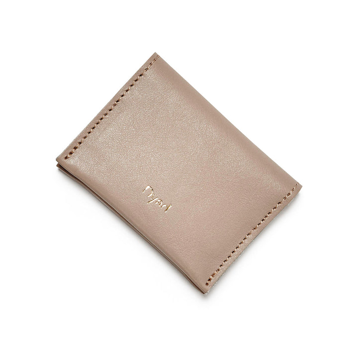 Project Dyad Wave Cardholder in Stone, closed with gold Dyad logo