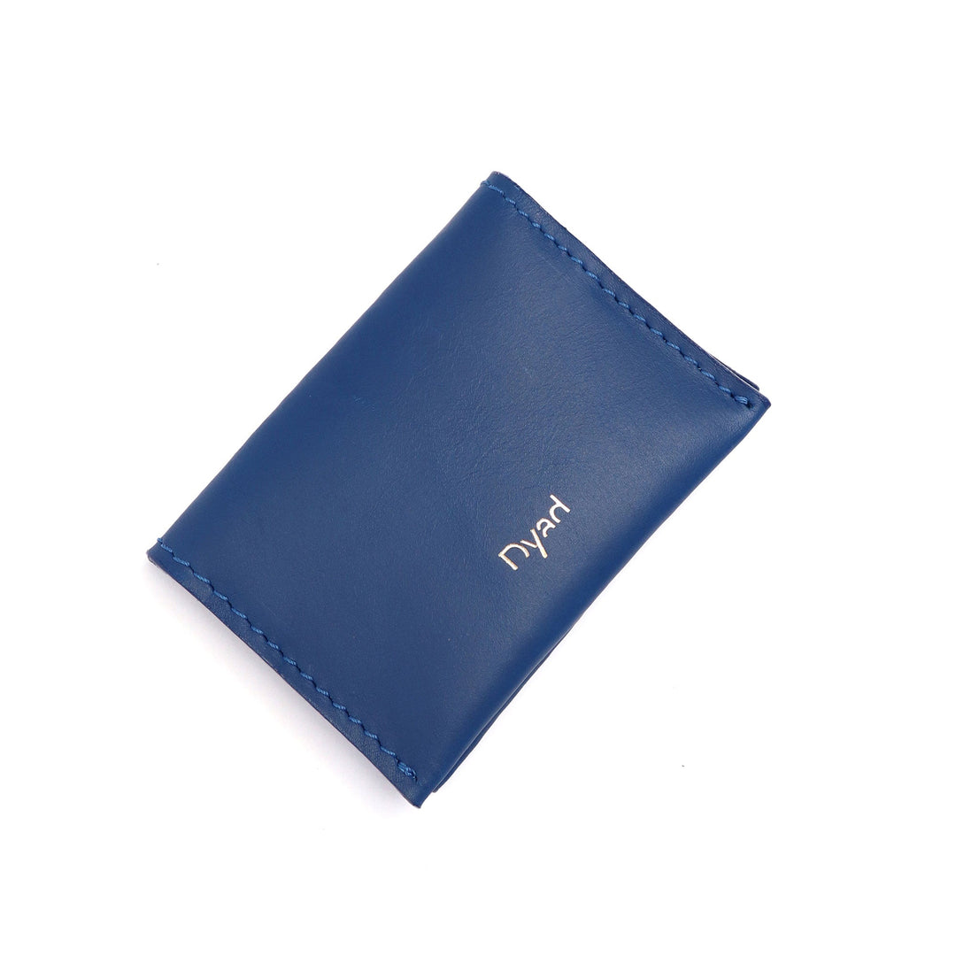 Project Dyad Wave Cardholder in Cobalt, closed with gold Dyad logo