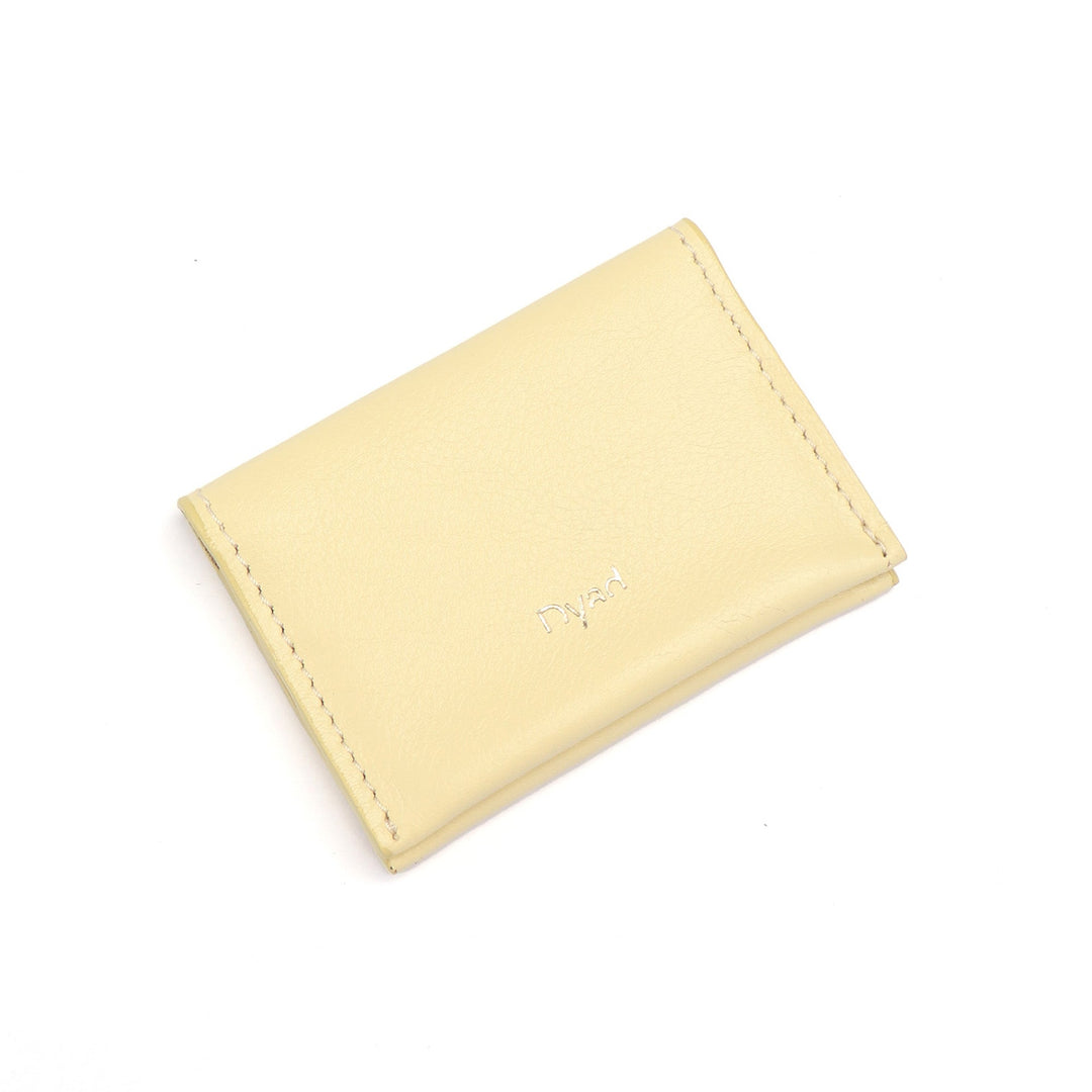 Project Dyad Wave Cardholder in Butter, closed with gold Dyad logo