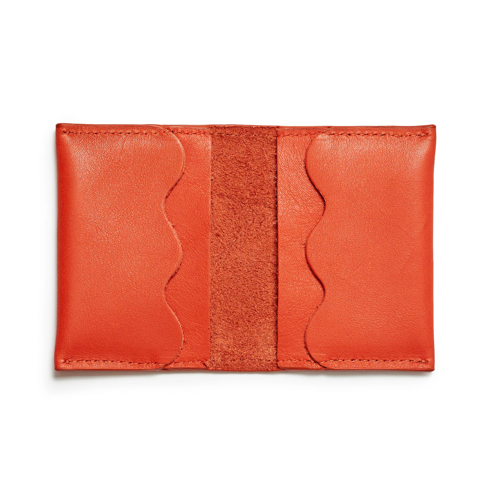 Project Dyad Wave Cardholder in Lobster Red, open showing wave-edged card compartments