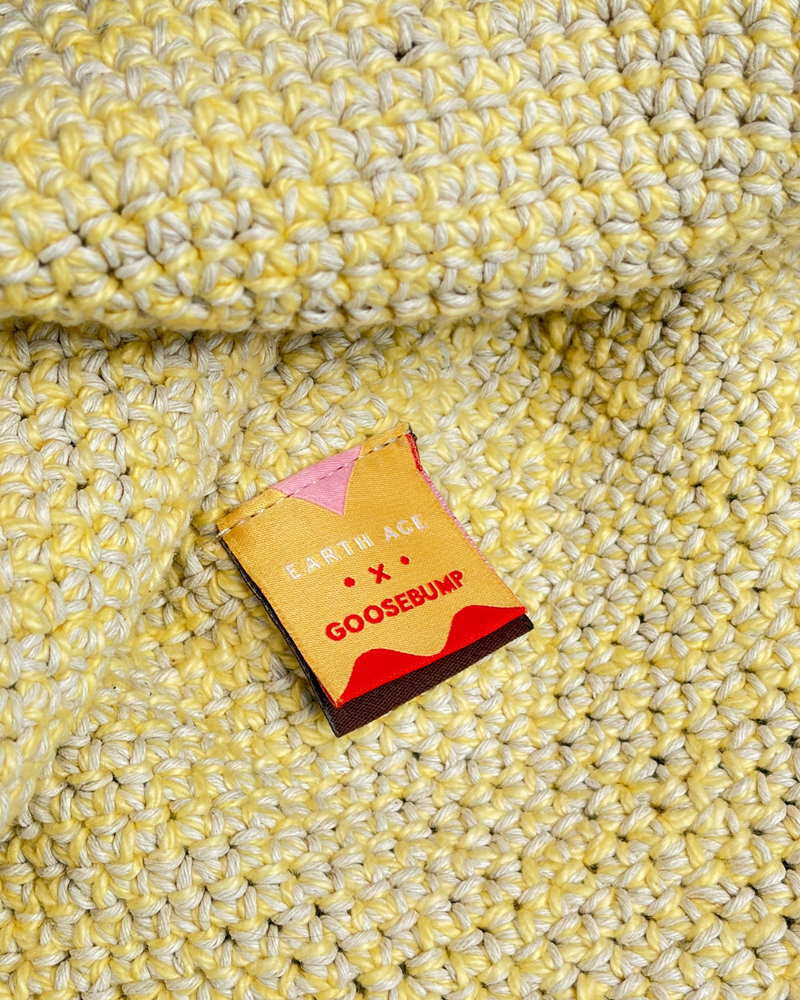 Front of the Goosebump-designed collaboration label in orange and cream yellow