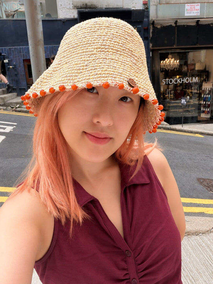 Earth Age × Goosebump Butter Yellow crochet hat with orange glass beads, worn outdoors