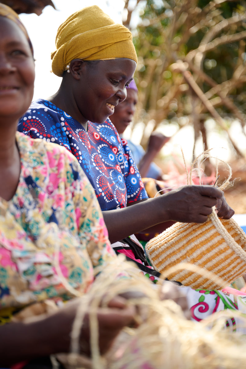 Official photograph of Kenyan women weaving together