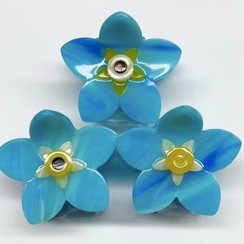 Official photograph of Forget-me-not hair claw prototypes
